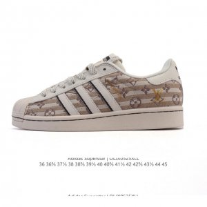 公司级 阿迪达斯 Adidas Superstar 2025年新款鞋子 蛇年新款经典贝壳头系列 新款休闲板鞋潮流男女士运动鞋 鞋面柔软织物拼接材质 标志性的贝壳